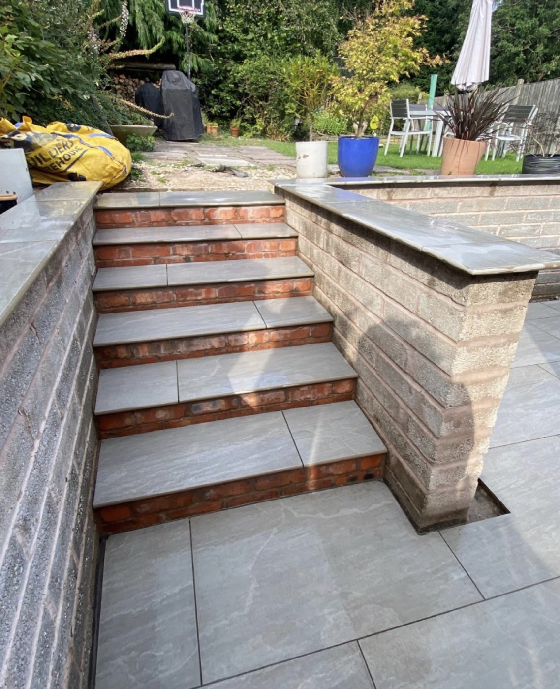 Porcelain paving and sleeper steps to a finished garden
